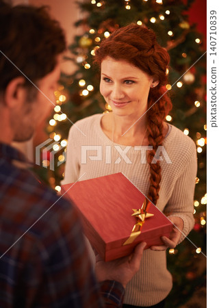 Couple, Christmas and gift for holiday celebration, festive and season of giving for love and commitment. Happy, gratitude and support with people at home for present, romance and relationship Couple, Christmas and gift for holiday celebration, festive and season of giving for love and commitment. Happy, gratitude and support with people at home for present, romance and relationship 140710839