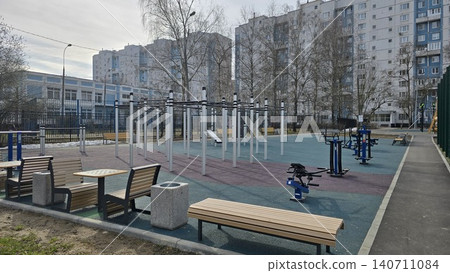 Empty urban gym for all ages and genders near diverse city residential apartment buildings. 140711084