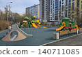 Empty colorful children playground equipment sits in a modern residential area with no people. 140711085