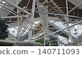 Indoor adventure park with metal structures and ropes courses for diverse men and women of all ages. 140711093