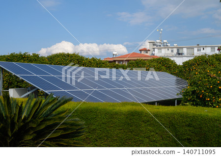 Solar panels harnessing sunlight in a vibrant coastal neighborhood during a clear day Solar panels harnessing sunlight in a vibrant coastal neighborhood during a clear day 140711095