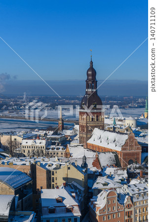 Riga Dome Cathedral Surrounded by Snowy Roofs of Old Town, Latvia Riga Dome Cathedral Surrounded by Snowy Roofs of Old Town, Latvia 140711109