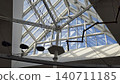 An indoor adventure park features a complex high ropes course built under a modern glass roof. 140711185