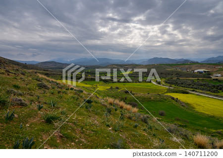 Expansive green hills and dramatic sky showcase nature's beauty in a serene Expansive green hills and dramatic sky showcase nature's beauty in a serene 140711200