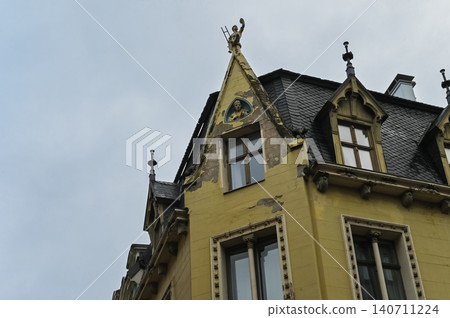 Yellow Cat House with Chimney Sweep Sculpture on Roof in Riga Old Town, Latvia 140711224