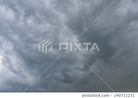 Dense dark storm clouds typical of thunderstorm or gale weather conditions often preceding brief Dense dark storm clouds typical of thunderstorm or gale weather conditions often preceding brief 140711231