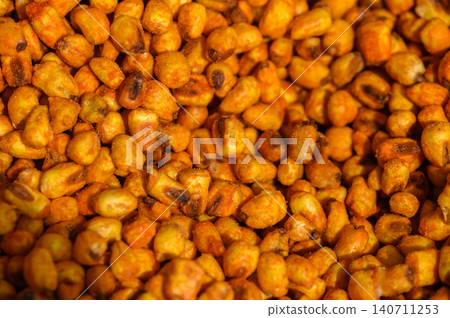 Golden roasted corn kernels create a delicious snack enjoyed at bustling markets during sunny afternoons Golden roasted corn kernels create a delicious snack enjoyed at bustling markets during sunny afternoons 140711253