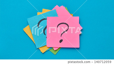 A stack of multi-colored square sticky notes with a question mark on them, concept of finding a solution and making a choice A stack of multi-colored square sticky notes with a question mark on them, concept of finding a solution and making a choice 140712059