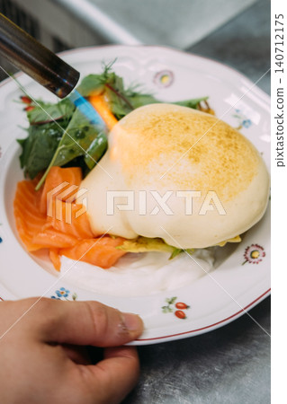 Gas torch. Gourmet breakfast. Chef cooking lunch with professional fire tool. Hand searing sauce with salmon slices green salad leaves. Gas torch. Gourmet breakfast. Chef cooking lunch with professional fire tool. Hand searing sauce with salmon slices green salad leaves. 140712175