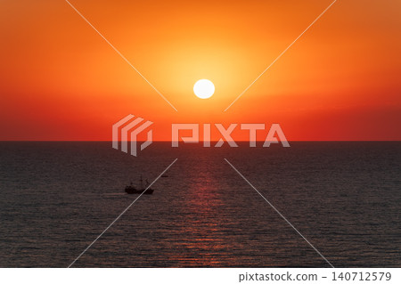 Beautiful red and orange sunrise over the sea. Beautiful red and orange sunrise over the sea. 140712579