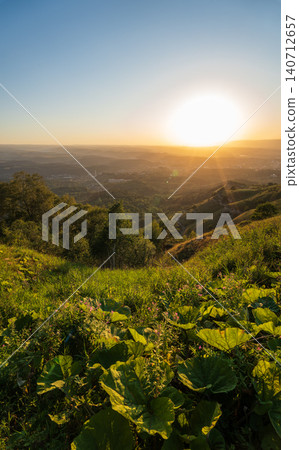 View of the mountains and Kislovodsk from the observation decks of the Kislovodsk Park. Evening sunset over the mountains of Kislovodsk. View of the mountains and Kislovodsk from the observation decks of the Kislovodsk Park. Evening sunset over the mountains of Kislovodsk. 140712657