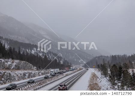 Interstate 70 Colorado Rocky Mountains Highway in Winter Snowfall with Traffic Through Mountain Interstate 70 Colorado Rocky Mountains Highway in Winter Snowfall with Traffic Through Mountain 140712790