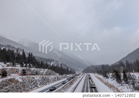 Interstate 70 Colorado Rocky Mountains Highway in Winter Snowfall with Traffic Interstate 70 Colorado Rocky Mountains Highway in Winter Snowfall with Traffic 140712802