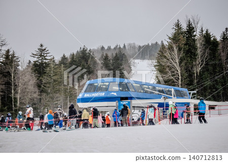 Snowshoe West Virginia Ski Resort with Chairlift Loading Area Skiers Snow Covered Slopes Snowshoe West Virginia Ski Resort with Chairlift Loading Area Skiers Snow Covered Slopes 140712813