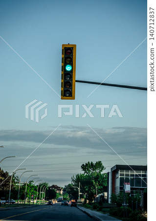 Green Traffic Light Hanging Quietly Above Calm Montreal City Street Evening Green Traffic Light Hanging Quietly Above Calm Montreal City Street Evening 140712837