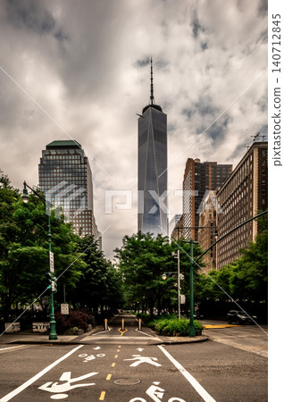 Lower Manhattan Streets Beneath Storm Clouds and Towering New York Skyscraper Lower Manhattan Streets Beneath Storm Clouds and Towering New York Skyscraper 140712845