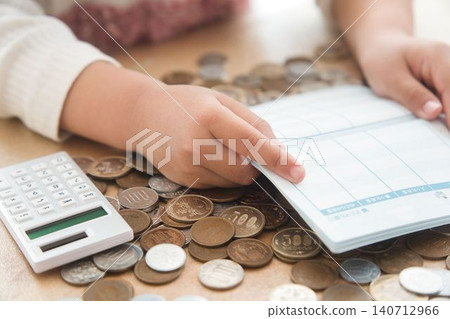 A child's hands calculating money A child's hands calculating money 140712966