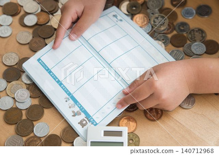 A child's hands calculating money A child's hands calculating money 140712968
