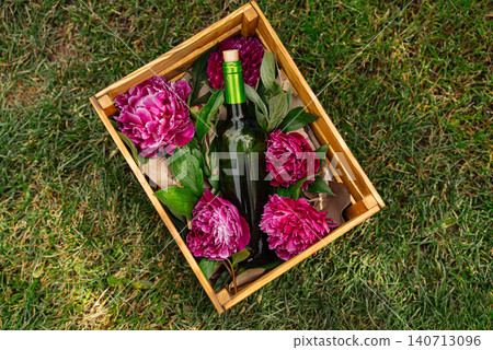 Chilled Wine Bottle Surrounded by Blooming Flowers in Elegant Garden Setting Chilled Wine Bottle Surrounded by Blooming Flowers in Elegant Garden Setting 140713096