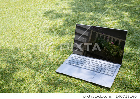Laptop placed on the grass Laptop placed on the grass 140713166