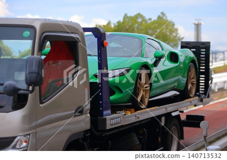 A car carrier (loader) carrying a sports car. A car carrier (loader) carrying a sports car. 140713532