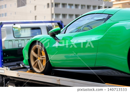 A car carrier (loader) carrying a sports car. A car carrier (loader) carrying a sports car. 140713533