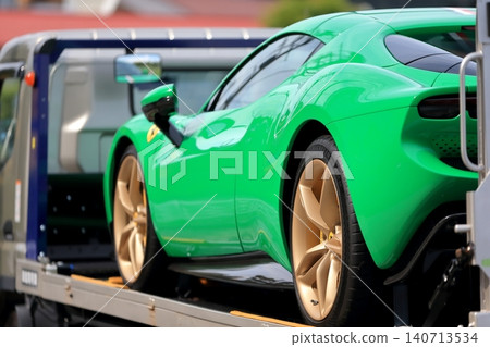 A car carrier (loader) carrying a sports car. 140713534