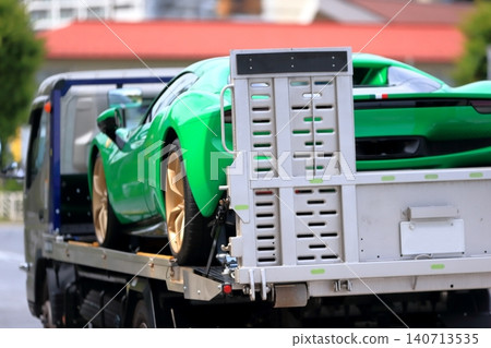 A car carrier (loader) carrying a sports car. A car carrier (loader) carrying a sports car. 140713535