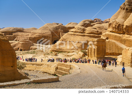 Petra, Wadi Musa, Jordan - Mar 06 2023, panoramic view of Siq Gorge canyon sandstone cliffs and rocks at daytime, Petra. Wadi Musa, Jordan Petra, Wadi Musa, Jordan - Mar 06 2023, panoramic view of Siq Gorge canyon sandstone cliffs and rocks at daytime, Petra. Wadi Musa, Jordan 140714333