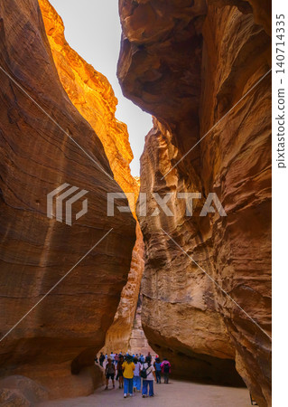 Petra, Wadi Musa, Jordan - Mar 06 2023, Siq Gorge, a narrow winding passage in canyon, vertically, Petra, Wadi Musa, Jordan 140714335