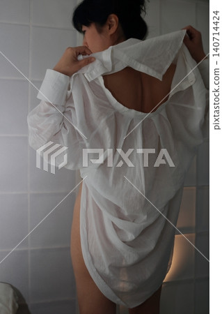 A clean and neat-looking woman's back view A clean and neat-looking woman's back view 140714424