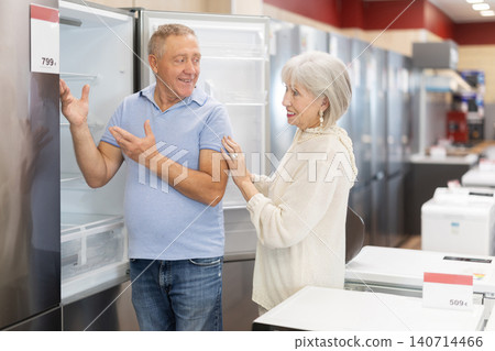 Elderly couple choosing fridge at household appliances store Elderly couple choosing fridge at household appliances store 140714466