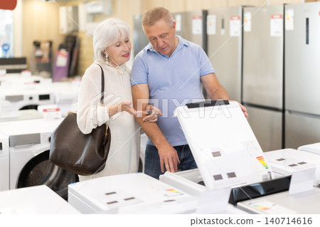 Elderly couple choosing a washing machine in a store 140714616