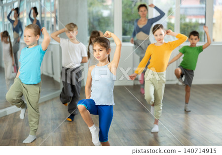 Girl learn to dance modern dances, doing movement with unrecognizable teacher. Girl learn to dance modern dances, doing movement with unrecognizable teacher. 140714915