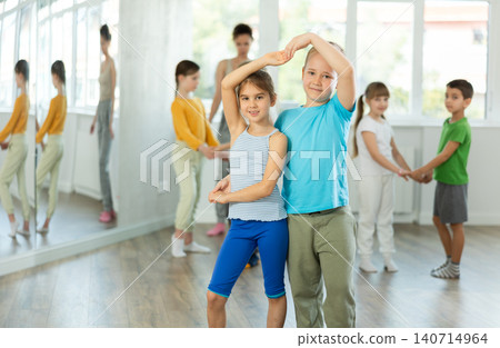 Preteen children learning to dance waltz in pairs in choreography class Preteen children learning to dance waltz in pairs in choreography class 140714964