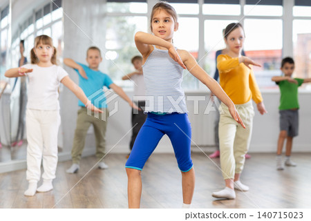 Girl learn to dance modern dances, doing movement with unrecognizable teacher. Girl learn to dance modern dances, doing movement with unrecognizable teacher. 140715023