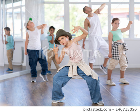 Girls and boys training hip hop in dance studio, dance classes for kids Girls and boys training hip hop in dance studio, dance classes for kids 140715050
