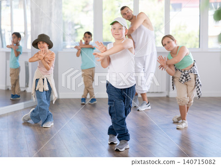 Children, together with dance teacher, practice hip-hop and breakdancing Children, together with dance teacher, practice hip-hop and breakdancing 140715082