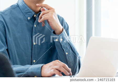 Hand of a man working on a computer Hand of a man working on a computer 140715103