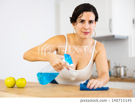 Positive woman keeping home clean and fresh during day, cleaning kitchen table Positive woman keeping home clean and fresh during day, cleaning kitchen table 140715145