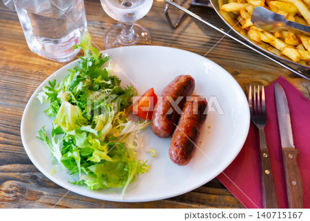 Traditional French savoy sausage with arugula on plate 140715167