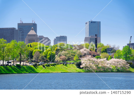 Cherry blossoms at Sakurada-bori in Tokyo, with a view of the National Diet Building. Cherry blossoms at Sakurada-bori in Tokyo, with a view of the National Diet Building. 140715290