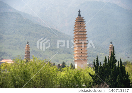 An iconic Three Pagodas in Dali old town, China. This is the cultural symbol of Dali. Located at the foot of Cangshan Mountain. An iconic Three Pagodas in Dali old town, China. This is the cultural symbol of Dali. Located at the foot of Cangshan Mountain. 140715527