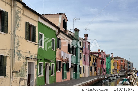 Colorful houses and boats lining the canals of Burano Island in Venice, Italy. Colorful houses and boats lining the canals of Burano Island in Venice, Italy. 140715673
