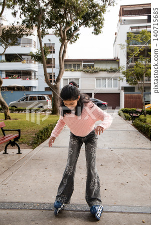 Young Girl Standing on Rollerblades in Park Path 140715685