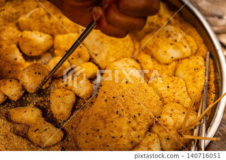 Hakka mochi, peanut powder, sesame powder, iron plate, bamboo skewers, ethnic dessert, traditional food Hakka mochi, peanut powder, sesame powder, iron plate, bamboo skewers, ethnic dessert, traditional food 140716051