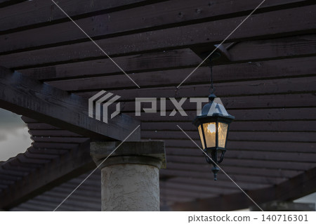 Warm Lantern Under Wooden Pergola 140716301
