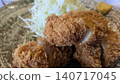 A close-up of a juicy pork loin cutlet with a crispy coating. 140717045