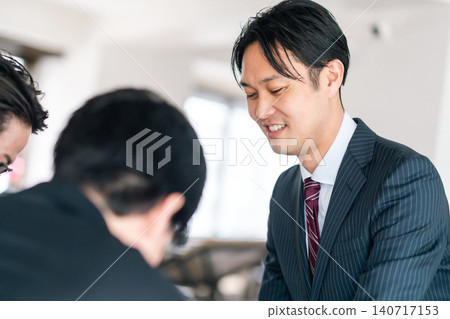 Business people smiling during a meeting 140717153