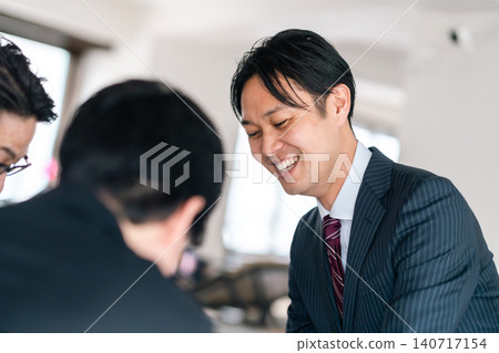 Business people smiling during a meeting Business people smiling during a meeting 140717154